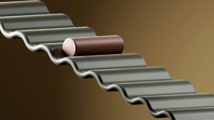 a roll of metal sitting on top of a brown wall